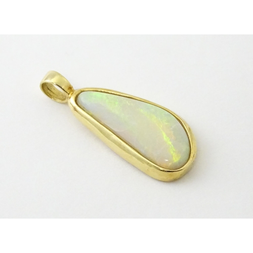 604 - A 14ct gold pendant set with central opal. Approx. 1 1/4