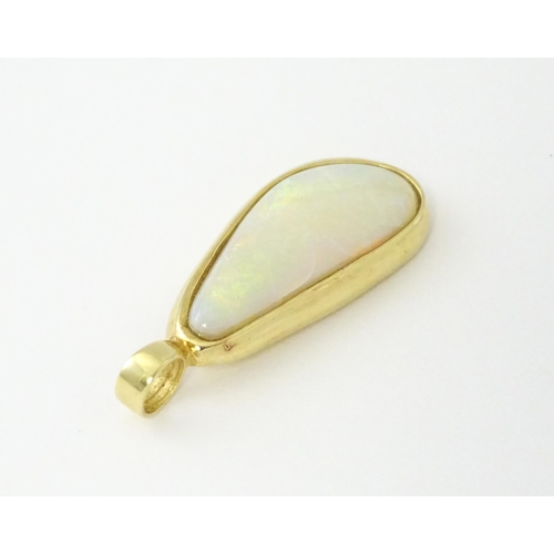 604 - A 14ct gold pendant set with central opal. Approx. 1 1/4