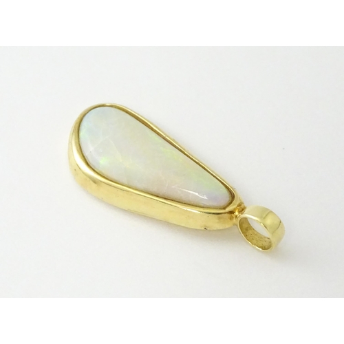 604 - A 14ct gold pendant set with central opal. Approx. 1 1/4