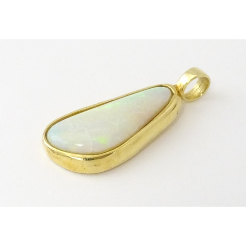 604 - A 14ct gold pendant set with central opal. Approx. 1 1/4