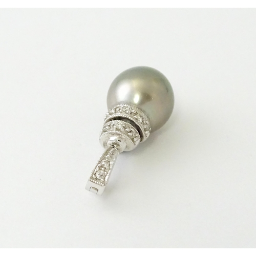 606 - An 18ct white gold pendant set with diamonds and a grey pearl. Approx. 1