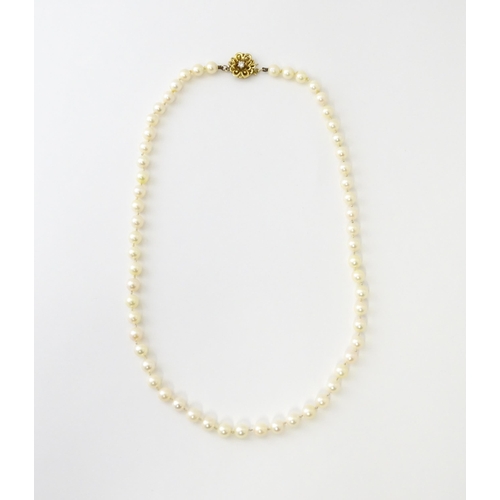 607 - A pearl necklace with 9ct gold clasp set with diamond. Approx. 20