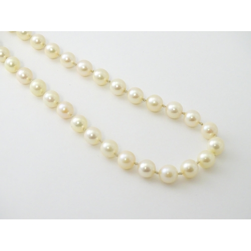 607 - A pearl necklace with 9ct gold clasp set with diamond. Approx. 20