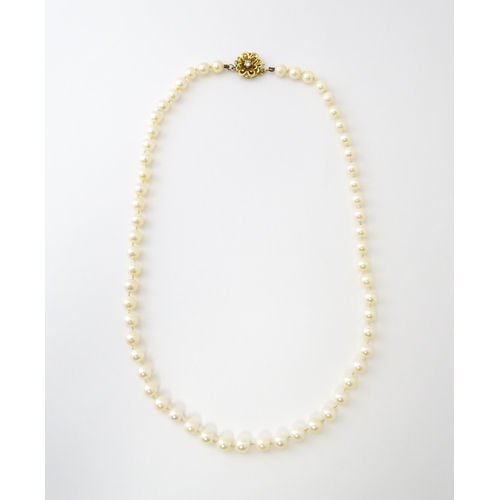 607 - A pearl necklace with 9ct gold clasp set with diamond. Approx. 20