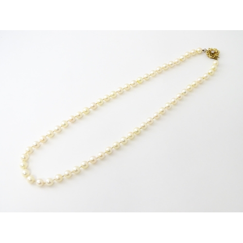 607 - A pearl necklace with 9ct gold clasp set with diamond. Approx. 20