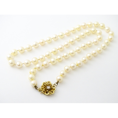 607 - A pearl necklace with 9ct gold clasp set with diamond. Approx. 20