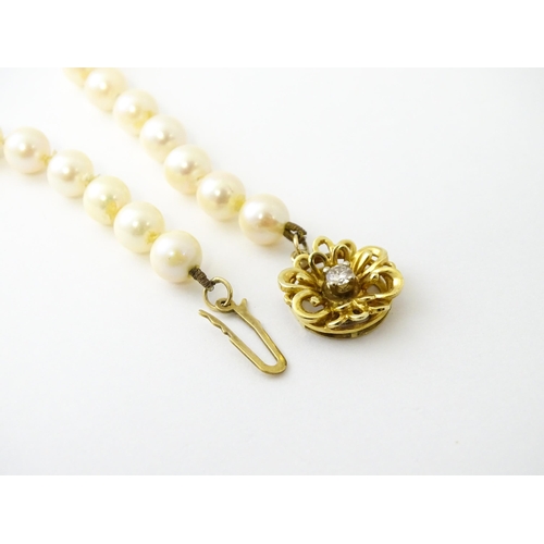 607 - A pearl necklace with 9ct gold clasp set with diamond. Approx. 20