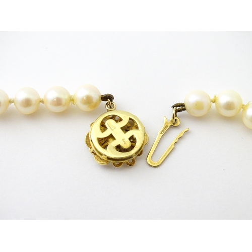 607 - A pearl necklace with 9ct gold clasp set with diamond. Approx. 20