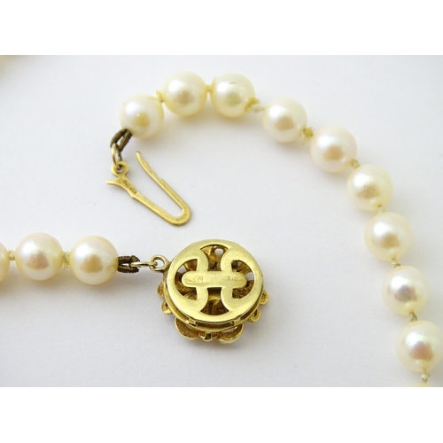 607 - A pearl necklace with 9ct gold clasp set with diamond. Approx. 20