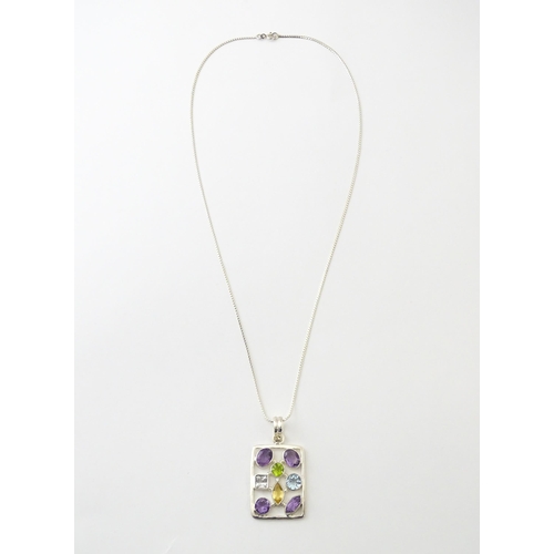 612 - A silver pendant set with coloured stones, with silver chain. Pendant approx. 2