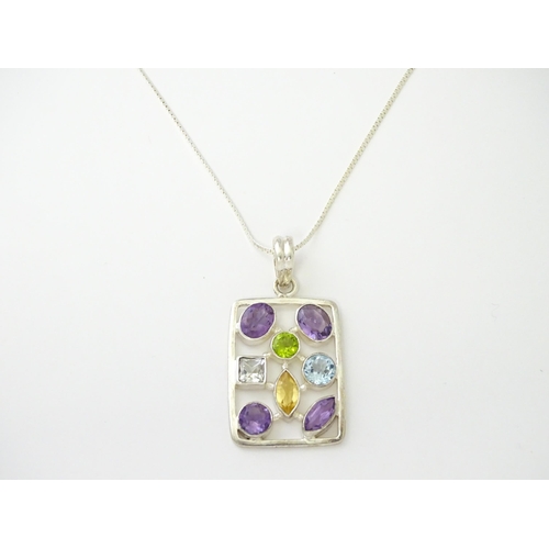 612 - A silver pendant set with coloured stones, with silver chain. Pendant approx. 2