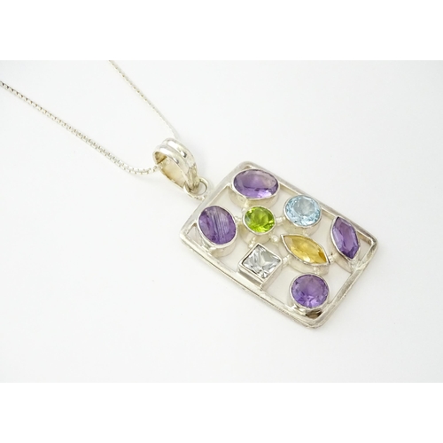 612 - A silver pendant set with coloured stones, with silver chain. Pendant approx. 2