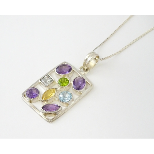 612 - A silver pendant set with coloured stones, with silver chain. Pendant approx. 2