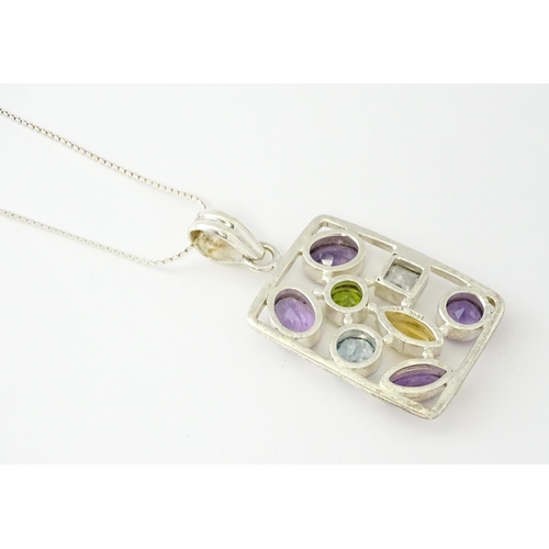 612 - A silver pendant set with coloured stones, with silver chain. Pendant approx. 2