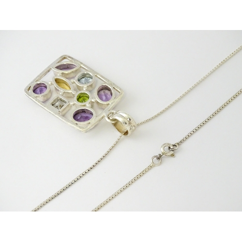 612 - A silver pendant set with coloured stones, with silver chain. Pendant approx. 2