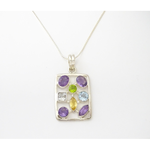 612 - A silver pendant set with coloured stones, with silver chain. Pendant approx. 2