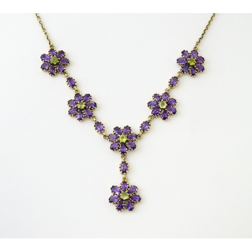 613 - A 9ct gold necklace set with amethyst and peridot. Approx. 19