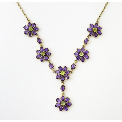 613 - A 9ct gold necklace set with amethyst and peridot. Approx. 19