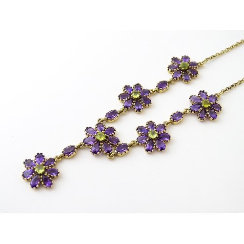 613 - A 9ct gold necklace set with amethyst and peridot. Approx. 19