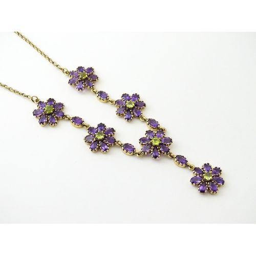 613 - A 9ct gold necklace set with amethyst and peridot. Approx. 19