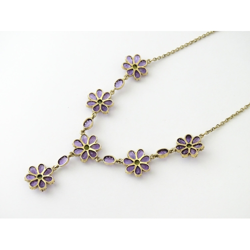 613 - A 9ct gold necklace set with amethyst and peridot. Approx. 19