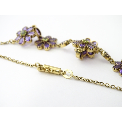 613 - A 9ct gold necklace set with amethyst and peridot. Approx. 19