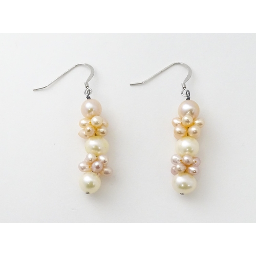 614 - A pair of silver drop earrings set with pearls. Approx. 1 1/2