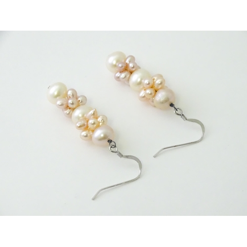 614 - A pair of silver drop earrings set with pearls. Approx. 1 1/2