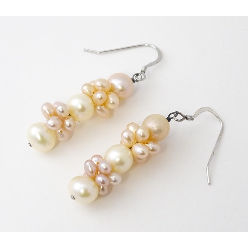 614 - A pair of silver drop earrings set with pearls. Approx. 1 1/2