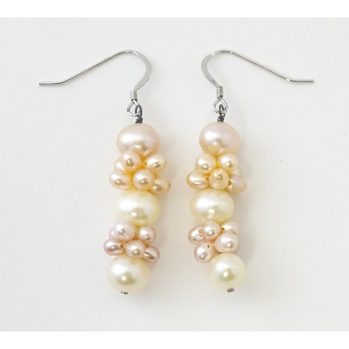 614 - A pair of silver drop earrings set with pearls. Approx. 1 1/2