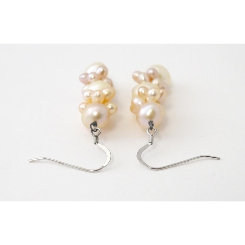 614 - A pair of silver drop earrings set with pearls. Approx. 1 1/2