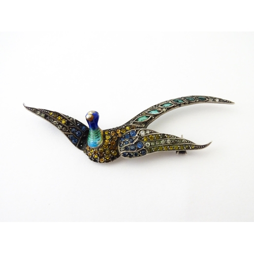 615 - A silver brooch modelled a pheasant in flight with guilloche enamel decoration and coloured stones, ... 