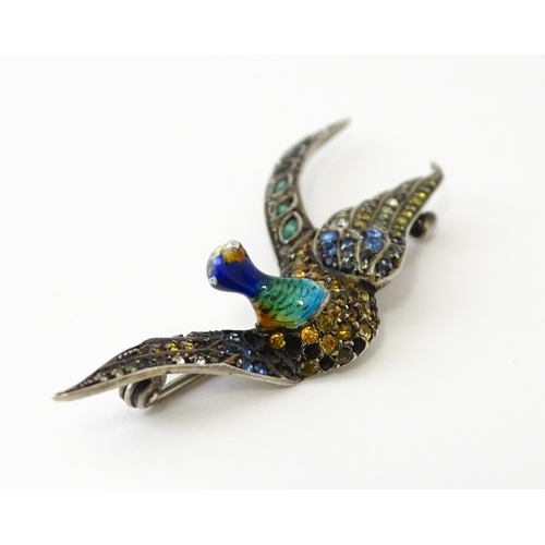 615 - A silver brooch modelled a pheasant in flight with guilloche enamel decoration and coloured stones, ... 