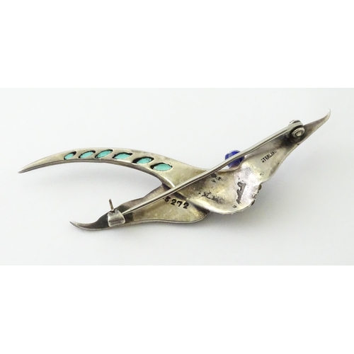 615 - A silver brooch modelled a pheasant in flight with guilloche enamel decoration and coloured stones, ... 