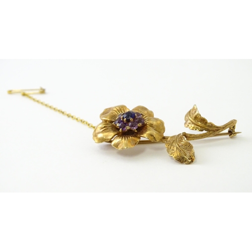 616 - A 9ct gold brooch of flower form set with central amethyst bordered by 7 further amethysts in a clus... 