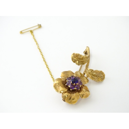 616 - A 9ct gold brooch of flower form set with central amethyst bordered by 7 further amethysts in a clus... 