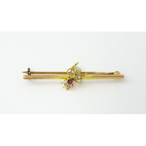 618 - A 9ct gold bar brooch with insect detail set with ruby and pearls. Approx. 1 3/4