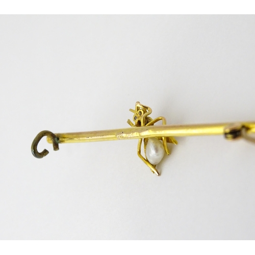 618 - A 9ct gold bar brooch with insect detail set with ruby and pearls. Approx. 1 3/4