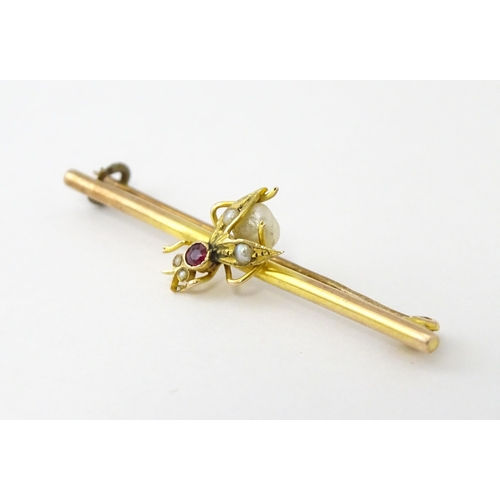 618 - A 9ct gold bar brooch with insect detail set with ruby and pearls. Approx. 1 3/4