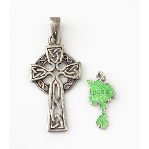 619 - A silver pendant formed as a Celtic cross. Together with a pendant charm formed as the Isle of Sark(... 