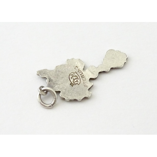 619 - A silver pendant formed as a Celtic cross. Together with a pendant charm formed as the Isle of Sark(... 