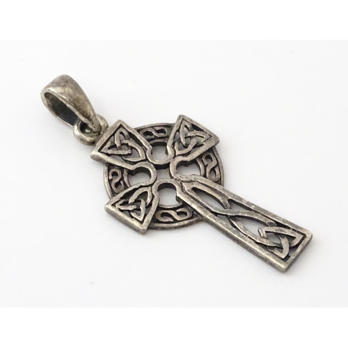 619 - A silver pendant formed as a Celtic cross. Together with a pendant charm formed as the Isle of Sark(... 