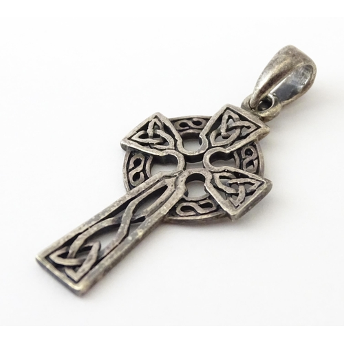 619 - A silver pendant formed as a Celtic cross. Together with a pendant charm formed as the Isle of Sark(... 