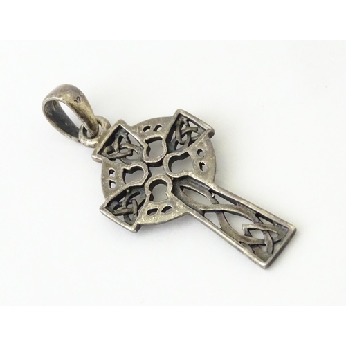 619 - A silver pendant formed as a Celtic cross. Together with a pendant charm formed as the Isle of Sark(... 