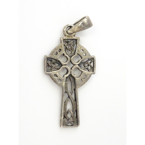 619 - A silver pendant formed as a Celtic cross. Together with a pendant charm formed as the Isle of Sark(... 