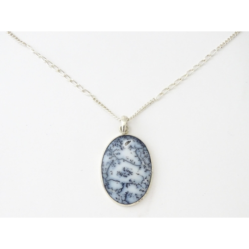 621 - A silver pendant set with dendrite agate, with a silver chain. Pendant approx. 2