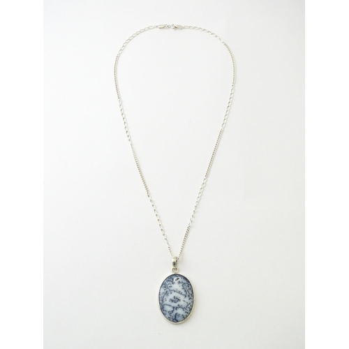 621 - A silver pendant set with dendrite agate, with a silver chain. Pendant approx. 2