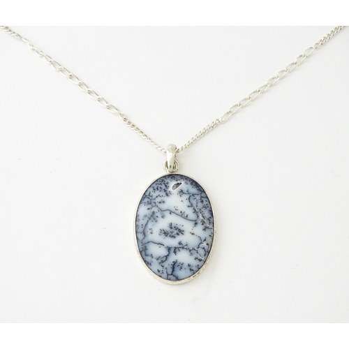 621 - A silver pendant set with dendrite agate, with a silver chain. Pendant approx. 2