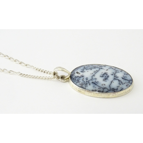 621 - A silver pendant set with dendrite agate, with a silver chain. Pendant approx. 2