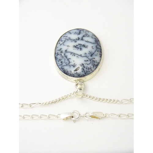 621 - A silver pendant set with dendrite agate, with a silver chain. Pendant approx. 2